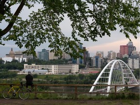 A cyclist looks over the river valley and downtown from Saskatchewan Drive in Edmonton, on Thursday, Aug. 6, 2020.