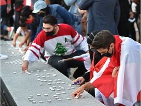 The Lebanese community organized a candlelight vigil for the victims of the deadly explosion in Beirut at the Alberta legislature in Edmonton, Aug.8, 2020.