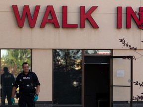 RCMP officers investigate a homicide at the Village Mall Clinic in Red Deer, south of Edmonton, on Monday, Aug. 10, 2020. A man was taken into custody.