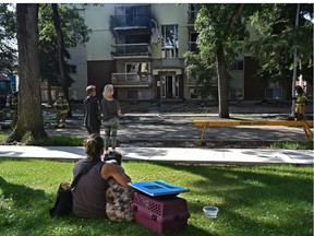 A number of residence evacuated their suites with pets in tow as firefighters on the scene of a fire that broke out on a third floor suite in a low rise apartment complex at 9911 85 Ave. in Edmonton, August 12, 2020.