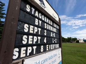 A sign communicating back-to-school plans is seen at Mount Royal Elementary in Edmonton, on Monday, Aug. 17, 2020. Schools are being prepared for the return of students during the COVID-19 pandemic.