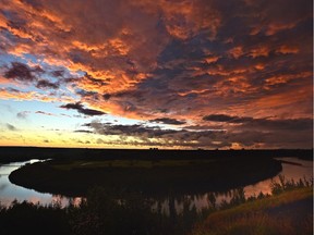 A firey sky appears over the North Saskatchewan River producing a spectacular full rainbow in the opposite direction of this photo, after a rain storm past through Edmonton in the late evening, August 24, 2020.