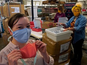 Unbelts employees Krista Kohuch, front, Tanis Zac, right, and Sabrina Sponagle, background, pack up masks the company is donating to schools, Sept. 4, 2020.