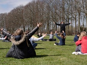 Teacher Rebekka Hjorth has music lessons with her 5.A class outdoors at the Korshoejskolen in Randers, on, April 15, 2020.  Denmark began reopening schools on April 15, 2020 for younger children after a month-long closure over the novel coronavirus, becoming the first country in Europe to do so.