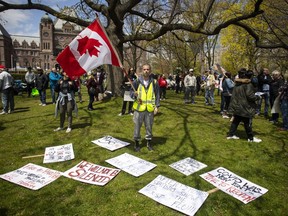 Researchers say conspiracy theories around COVID-19 are spreading at an alarming rate across the country -- and they warn that misinformation shared online may lead to devastating consequences and push Canadians to shun important safety measures. Protesters gather outside the Ontario Legislature in Toronto, as they demonstrate against numerous issues relating to the COVID-19 pandemic on Saturday, May 16, 2020.