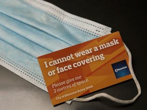 A City of Edmonton face mask exemption card, in Edmonton Monday Aug. 10, 2020. In response to COVID-19 a City of Edmonton bylaw requiring people to wear face masks in all public indoor spaces went into effect Aug. 1, 2020. However, the City has begun issuing face mask exemption cards at Edmonton recreation centres.