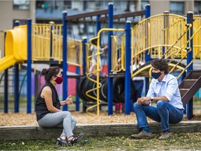 Canadian Prime Minister Justin Trudeau chats with mother of four, Joann Luong before making an announcement at Yorkwoods Public School in Toronto, Ont. on Wed. Aug. 26, 2020.