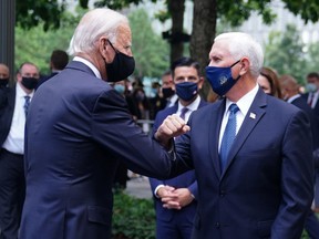 Democratic presidential candidate and former U.S. Vice President Joe Biden (L) and U.S. Vice President Mike Pence greet each other at ceremonies marking the 19th anniversary of the September 11, 2001 attacks on the World Trade Center at the 911 Memorial & Museum in the Manhattan borough of New York City, New York, U.S., September 11, 2020.