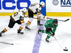 Andrew Cogliano (No. 11) of the Dallas Stars is pursued by Nicolas Roy (No. 10) and Mark Stone (No. 61) of the Vegas Golden Knights during the second period in Game 4 of the Western Conference Final during the 2020 NHL Stanley Cup Playoffs at Rogers Place on September 12, 2020.
