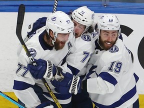 Anthony Cirelli (71) of the Tampa Bay Lightning is congratulated by his teammates after scoring the game-winning goal against the New York Islanders during the first overtime period to win Game 6 of the Eastern Conference Final during the 2020 NHL Stanley Cup Playoffs at Rogers Place on September 17, 2020.