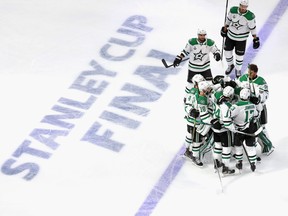 Corey Perry (10) of the Dallas Stars is congratulated by his teammates after scoring the game-winning goal in the second overtime period against the Tampa Bay Lightning to give the Stars a 3-2 victory in Game 5 of the 2020 NHL Stanley Cup Final at Rogers Place on Sept. 26, 2020.