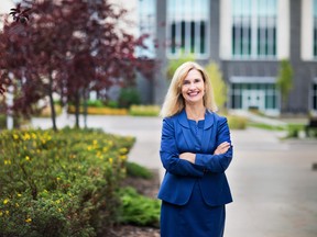 Woman in business attire in post-secondary setting