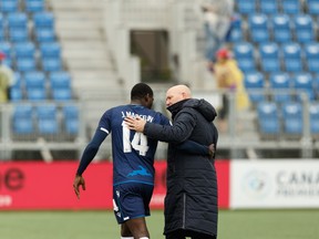 FC Edmonton's head coach Jeff Paulus (right) speaks with James Marcelin (14) after the team beat the HFX Wanderers FC 2-0 during Canada Premier League soccer action at Clarke Stadium in this file photo from July 1, 2019.