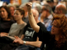 A crowd member raises a fist as Gil McGowan, president of the Alberta Federation of Labour speaks during the Join the Resistance Town Hall at MacEwan University in Edmonton, on Monday, Dec. 2, 2019.