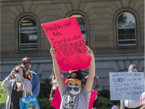 A few hundred people rallied at the Alberta legislature against the UCP education cuts on July 14, 2020.