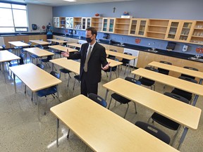 Principal Michael Kovacs speaks to media in a classeroom during tour of St. John XXIII K-9 school to show the changes that have been made for the safety of all students and staff when classes resume. Aug. 28, 2020.