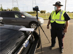 Const. Clint Stallknecht monitors drivers speed with a laser speed mearsurment device near Velma Chalifoux School on Thursday, Sept. 3, 2020 in Edmonton. Edmonton Police Service is reminding all drivers and pedestrians to remain safe and respect all of the rules of the road near schools, including the maximum Playground Zone speed of 30 km/h.