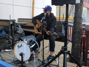 Leo Martinez performs on the Cask & Barrel patio.