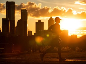A runner exercises at sunset through Forest Heights Park in Edmonton, on Tuesday, Sept. 15, 2020.