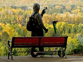 A man records a colorful autumn scene of Edmonton's river valley on Wednesday September 23, 2020.