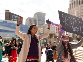 Organizer Chevi Rabbit (centre) and supporters take to the streets in a celebration of culture and history during Walk A Mile in Her Ribbon Skirt in Edmonton, on Saturday, Sept. 26, 2020. The event was held to share the perspectives of Indigenous women and to re-Indigenize the streets of Alberta's capital. Photo by Ian Kucerak/Postmedia