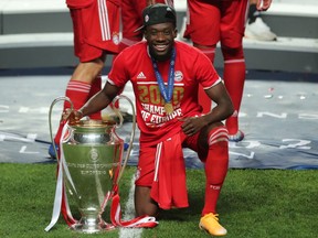 Canadian midfielder Alphonso Davies celebrates with the trophy after the UEFA Champions League final between Paris Saint-Germain and Bayern Munich at the Luz stadium in Lisbon on August 23, 2020.