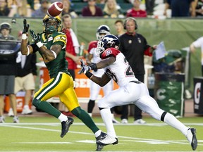 Edmonton Football Club receiver Fred Stamps (2) gets under a pass ahead of Calgary Stampeders Brandon Smith (28) at Commonwealth Stadium in this file photo from the Labour Day Rematch on Sept. 6, 2013.
