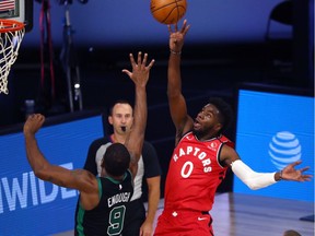 Toronto Raptors guard Terence Davis (0) shoots over Boston Celtics guard Brad Wanamaker (9) during the second half of game five of the second round in the 2020 NBA Playoffs at ESPN Wide World of Sports Complex.