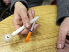 Ashley, a 24 year-old meth user, holds some of her drug paraphenalia while visiting harm reduction agency, ARCHES in Lethbridge on Wednesday Oct. 25, 2017.