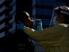 Community paramedic Katrina Petrosky performs COVID-19 nasal swab testing outside Boyle Street Community Services, in downtown Edmonton Wednesday Sept. 9, 2020.