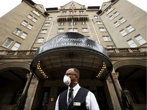 Doorman Amir Abdullahi waits for customers outside the Fairmont Hotel Macdonald, in Edmonton Thursday July 2, 2020.