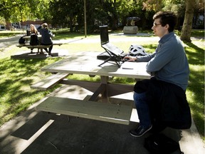 University of Alberta Ryan Kisslinger works on his laptop in the university quad, in Edmonton Tuesday Sept. 1, 2020. On the the first day of the fall session the university experienced disruptions to it's eClass online system. Photo by David Bloom