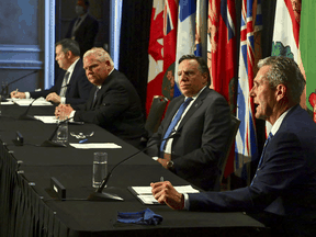 Manitoba Premier Brian Pallister, right, speaks during a press conference in Ottawa alongside Quebec Premier Francois Legault, Ontario Premier Doug Ford, and Alberta Premier Jason Kenney on Friday, Sept. 18, 2020.
