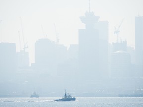 Smoke fills the sky and blankets the Vancouver skyline, Tuesday, Sept. 8, 2020. Metro Vancouver has issued an air quality advisory due to the smoke from wildfires burning in the northwestern United States.
