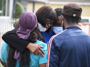 Fletcher Fair (second from left), the aunt of Dijon Kizee, who was fatally shot by Los Angeles County sheriff's deputies, is comforted after speaking at a press conference September 1, 2020 in Los Angeles.