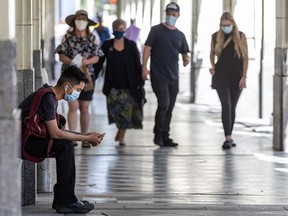 People are wearing masks while spending time in downtown Calgary on Monday, August 10, 2020.