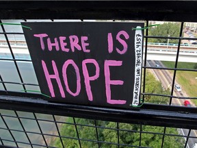 A homemade sign attached to the High Level Bridge in Edmonton Alta., on Friday Aug. 15, 2014.
