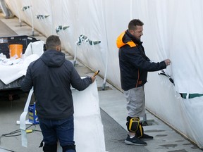 Crews work to repair approximately 20 slashes to the inflatable dome at Foote Field in Edmonton on Thursday, Sept. 17, 2020. The cuts to the dome were between six feet and 12 feet long.