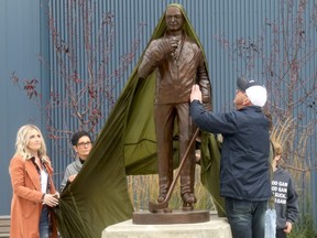 Darcy Haugan's family unveils a statue in his honour in front of the Baytex Energy Centre in Peace River, Alta. on Saturday, Oct. 10, 2020. Haugan was the former head coach of the North Peace Navigators and Humboldt Broncos.