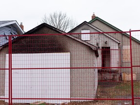 Fire damage is seen on a boarded up house near 97 Street and 109A Avenue in Edmonton, on Friday, Oct. 30, 2020. Edmonton Fire Rescue Service firefighters extinguished a fire in the basement of the house in the early morning