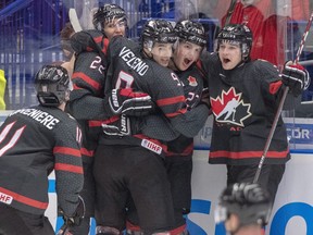 Canada's Dylan Cozens (22, back left) celebrates with teammates (left to right) Alexis Lafreniere, Joe Veleno, Barrett Hayton and Calen Addison after scoring the first goal against Russia during second period action in the gold medal game at the World Junior Hockey Championships, Sunday, Jan. 5, 2020 in Ostrava, Czech Republic.