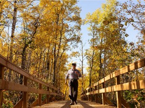 Haiyan Tu walks in Emily Murphy Park surrounded by fall colours in Edmonton, on Wednesday, Sept. 30, 2020.