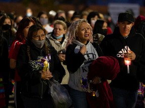 Angela Chalifoux, centre, mother of Sierra Chalifoux-Thompson, is surrounded by family and supporters during a candlelight vigil to remember her daughter on Thursday, Oct. 8, 2020.