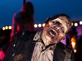 A zombie is seen scaring up Halloween fun at the Deadmonton Haunted House at 7031 Gateway Blvd NW, on Friday, Oct. 9, 2020. Deadmonton has adopted COVID-19 safety measures during the pandemic.