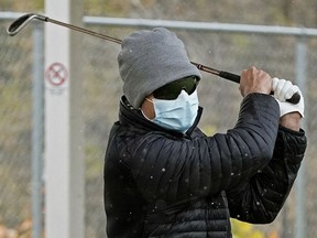 Raj Padwal gets a few last golf swings in before the snow flies at the Victoria Golf Driving Range in Edmonton on Friday, Oct. 16, 2020.