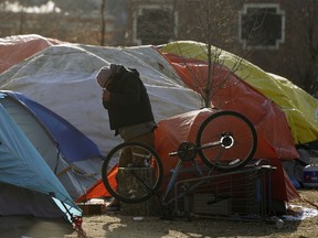 A man in the homeless camp near the river valley just south of downtown Edmonton on Sunday, Oct. 25, 2020. The City of Edmonton is preparing the Edmonton Convention Centre to house and feed the homeless population through the winter.