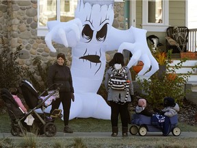 Stephanie Desjarlais, left, and her children Ivy and Allen takes a stroll with Parveen Kalirai and her children Nyiah and Zo on Grande Boulevard in Summerside, Wednesday, Oct. 28, 2020.