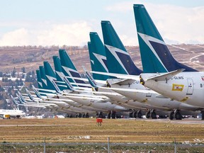 Sidelined WestJet Boeing 737 jets are stored on an unused runway at Calgary International Airport on Wednesday, October 14, 2020.