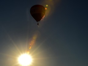 A hot air balloon floats over the setting sun in south Edmonton, October 2, 2020. Ed Kaiser/Postmedia