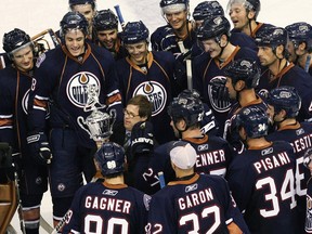 Edmonton Oilers locker-room attendant Joey Moss carries the Joey Moss Cup through a crowd of Edmonton Oilers after the inter-squad game in this file photo from Sept. 21, 2008.
